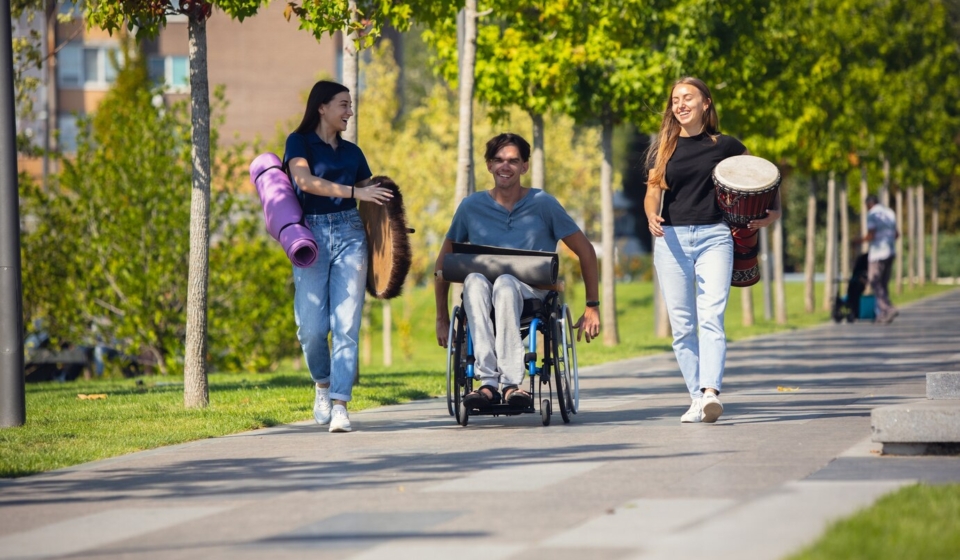 happy-handicapped-man-wheelchair-spending-time-with-friends-playing-live-instrumental-music-outdoors_155003-19200