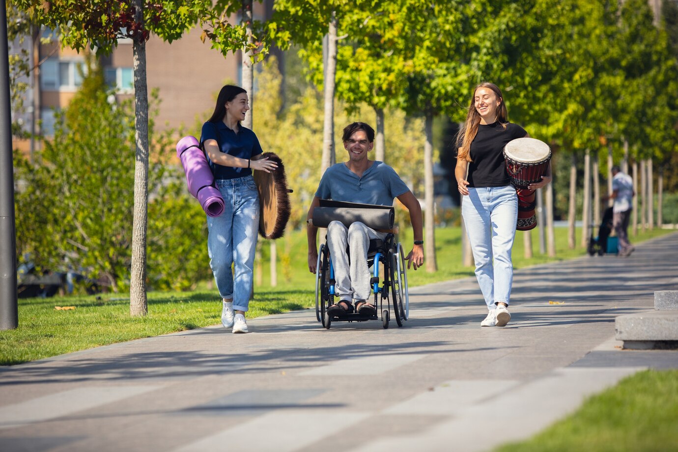 happy-handicapped-man-wheelchair-spending-time-with-friends-playing-live-instrumental-music-outdoors_155003-19200