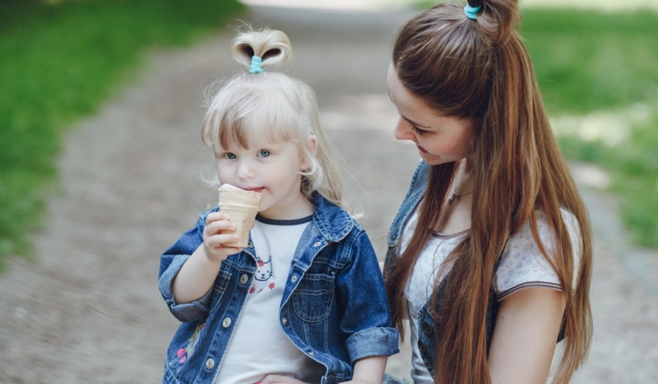 mother-looking-her-daughter-while-eating-ice-cream_1157-843